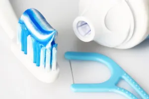 toothbrush with toothpaste and floss
